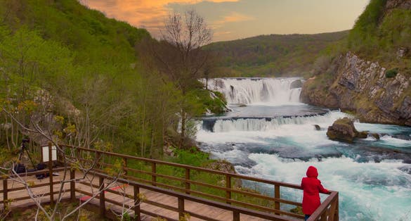 Photo of tourist enjoying the view of Strbacki Buk waterfall ,border between Croatia And Bosnia And Herzegovina, Europe.