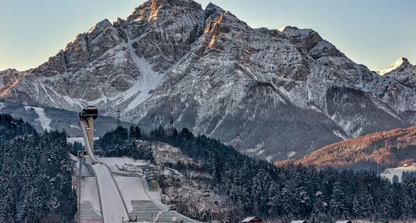 photo of Innsbruck Ski Jump with Serles Mountain in the background in Austria.