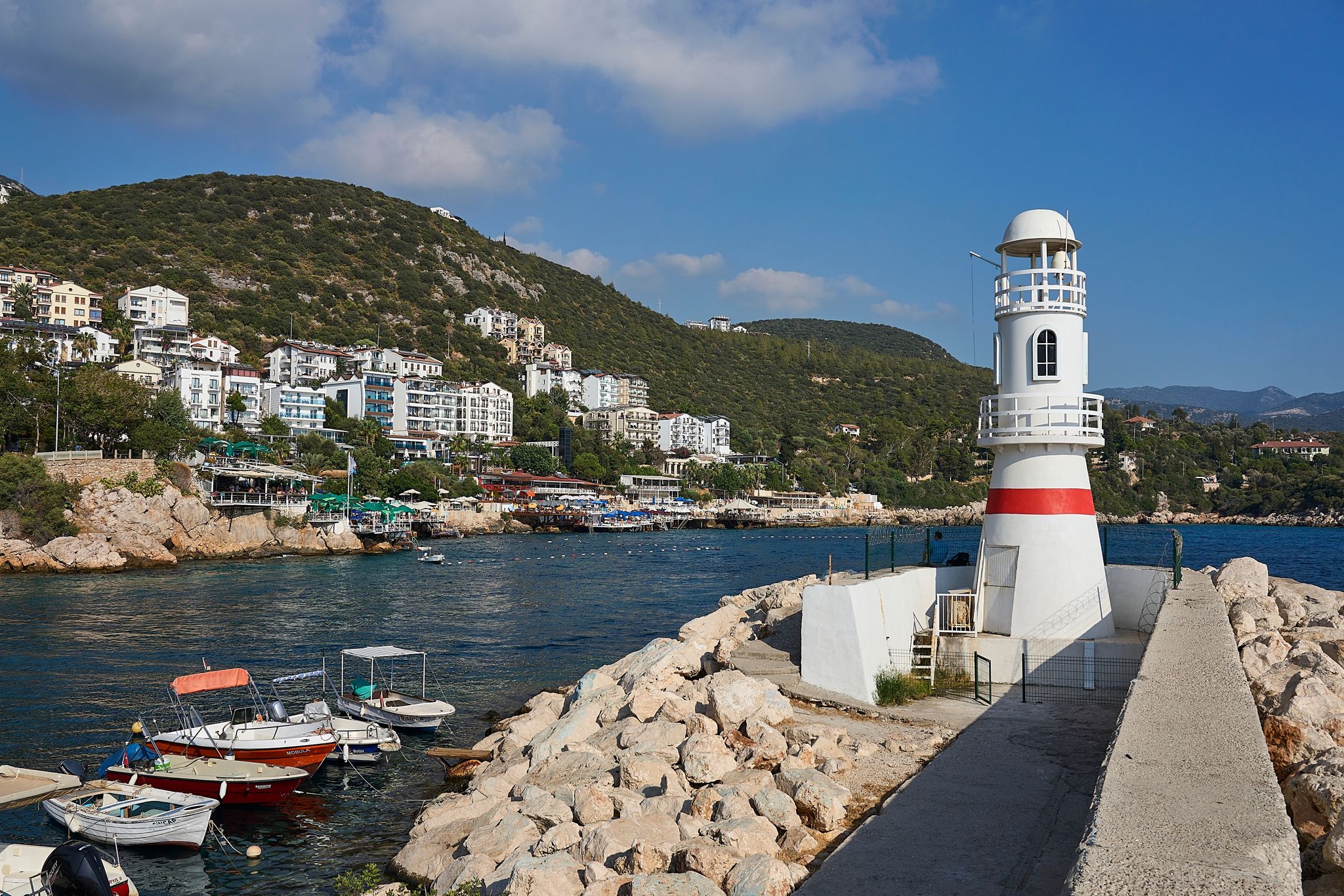 Lighthouse (aka deniz feneri) of Kaş, at the entrance of harbour. Taken on a beautiful calm summer day, Antalya province of Turkey.