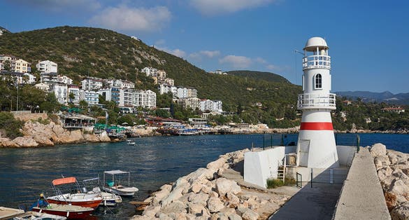 Lighthouse (aka deniz feneri) of Kaş, at the entrance of harbour. Taken on a beautiful calm summer day, Antalya province of Turkey.