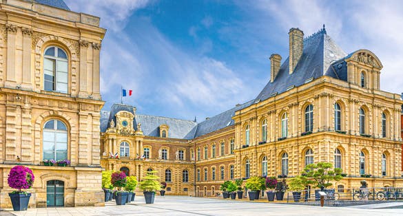 Amiens City hall Hotel de ville is a town hall neo-classical architecture style stone brick building with French flag in Amiens old historical city centre, Somme department, Hauts-de-France Region