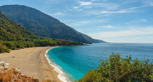 Photo of Kidrak beach with turquoise water near Oludeniz town on the coast of Mugla region in Turkey on summer day.