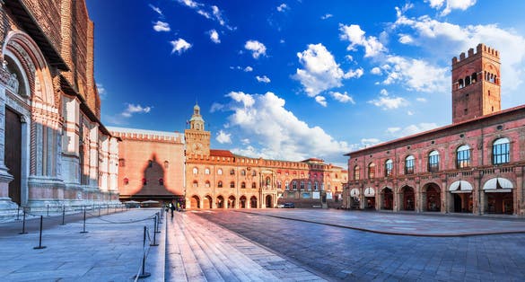 photo of bologna, Italy. Piazza maggiore with torre dell'orologio and torre dell’arengo, landmark in emilia-romagna historical province.