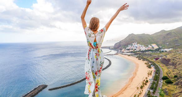 Photo of traveler girl enjoying the beach of Las Teresitas and San Andres village, Tenerife, Canary Islands, Spain. 