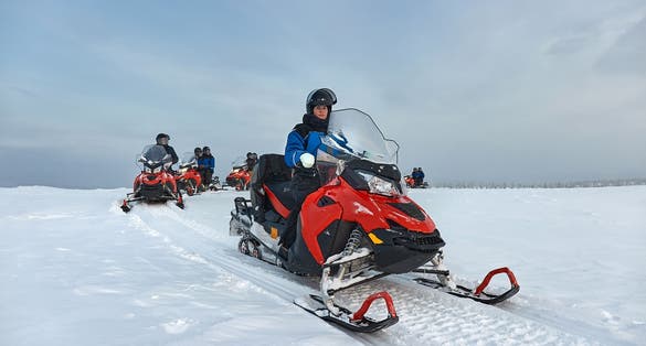 Photo of Riding on a snowmobile in Finland, female rider above the Arctic Circle