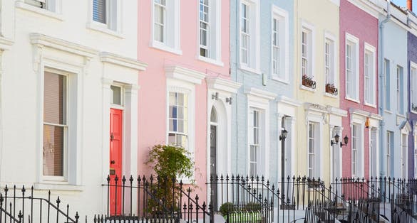 Photo of colorful English houses facades, pastel pale colors in London.