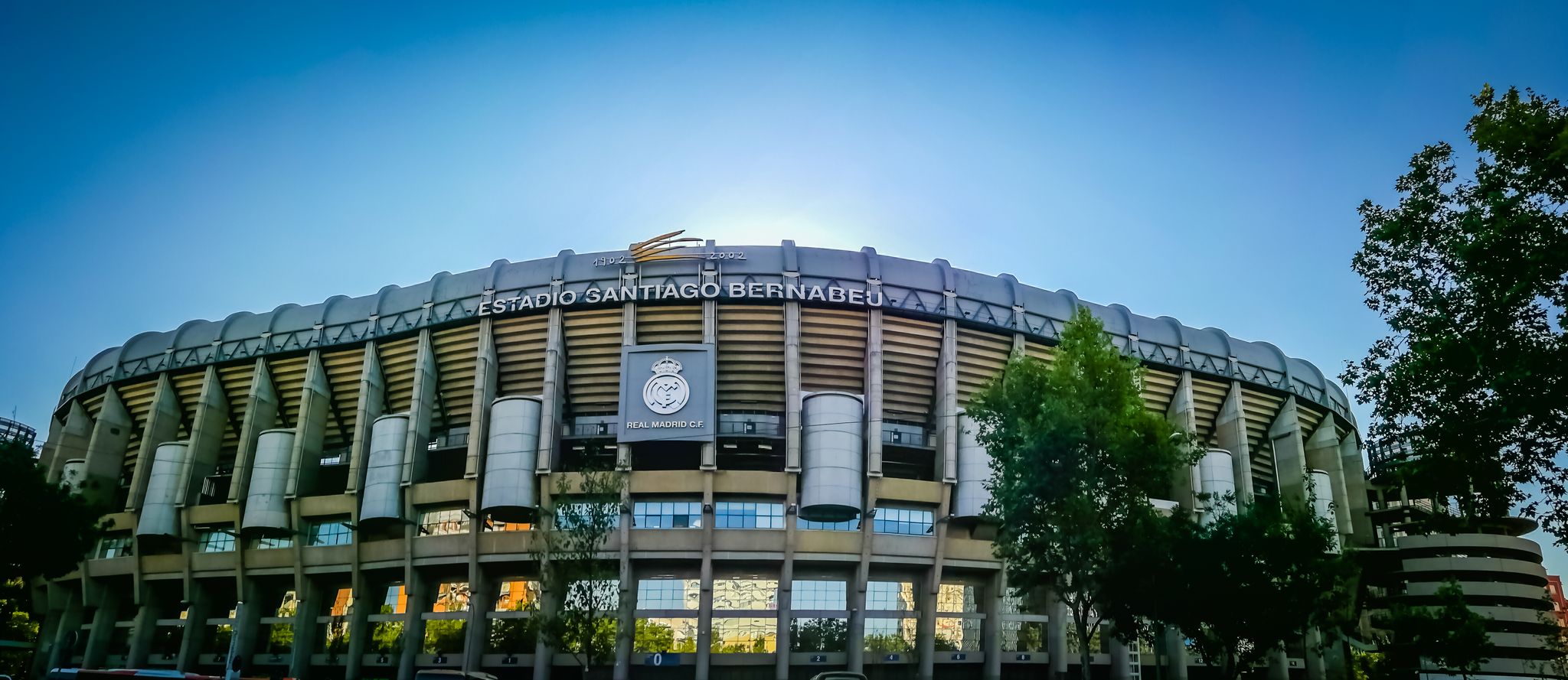 Photo of a gorgeous panoramic wide angle view of the main entrance to the Santiago Bernabeu soccer or football stadium. 