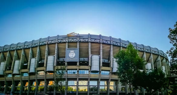 Photo of a gorgeous panoramic wide angle view of the main entrance to the Santiago Bernabeu soccer or football stadium. 