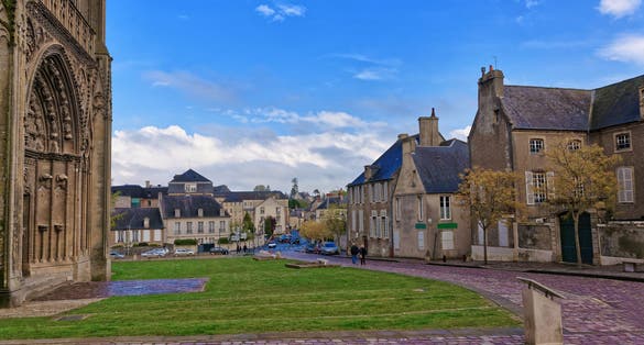 Photo of street and fragment of Cathedral of Our Lady of Bayeux in Calvados department of Normandy, France.