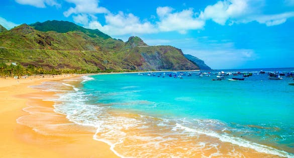 Photo of beautiful sandy beach in Tenerife with blue sky, Canary Islands, Spain.
