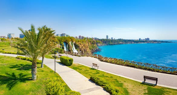 Photo of panoramic aerial view of water cascading from platform into Mediterranean sea in Antalya, Turkey.