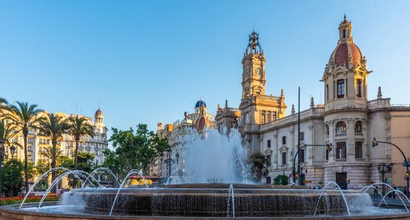 photo of Plaça de l'Ajuntament is a town hall behind a fountain in Spanish town Valencia, Spain.