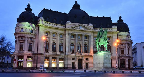 Photo of The Central University Library, old building in Bucharest with statue of King Carol I of Romania.