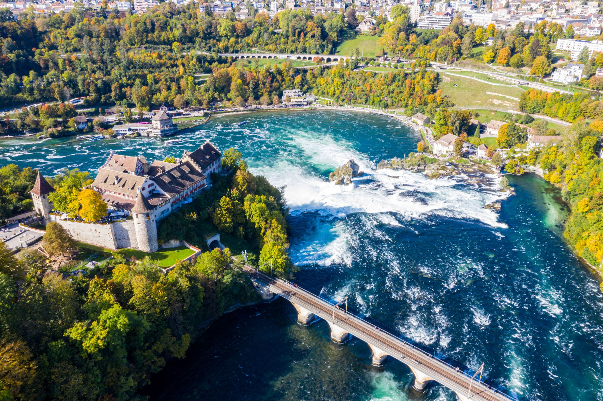Photo of red roofs and towers of cliff-top Schloss Laufen castle, Laufen-Uhwiesen. Rhine Falls or Rheinfall, Switzerland.