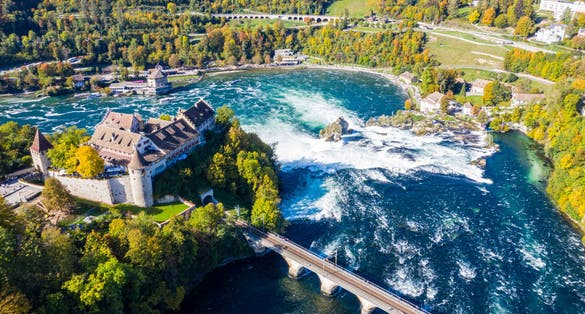 Photo of red roofs and towers of cliff-top Schloss Laufen castle, Laufen-Uhwiesen. Rhine Falls or Rheinfall, Switzerland.