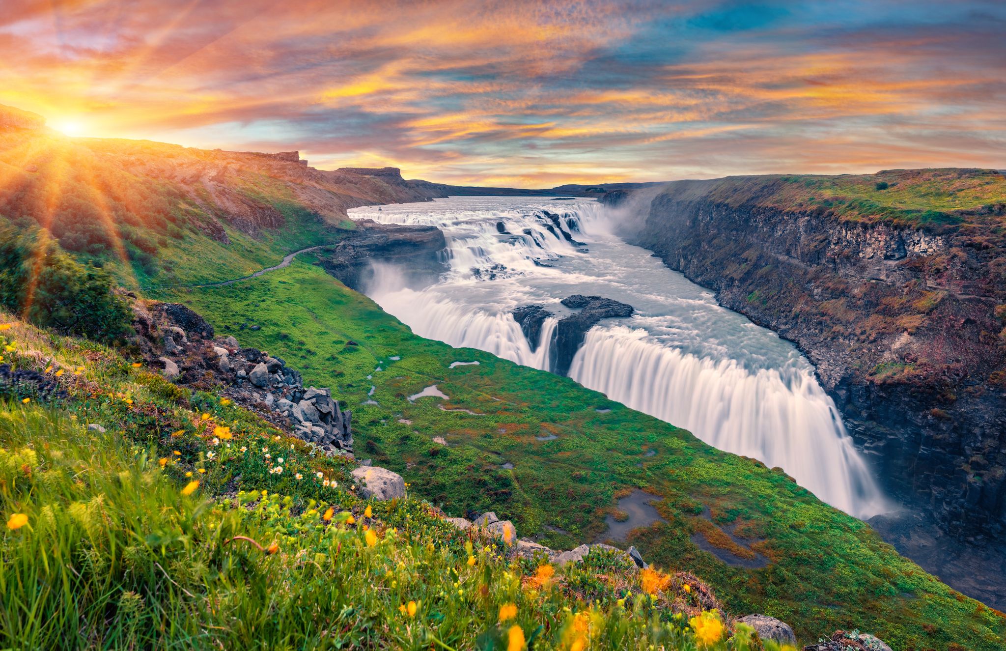photo of wonderful summer view of popular tourist destination - Gullfoss waterfall. Spectacular sunrise on hvita river. Gorgeous morning scene of Iceland, Europe. Traveling concept background.