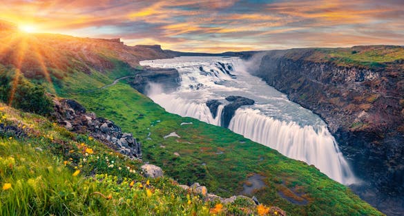 photo of wonderful summer view of popular tourist destination - Gullfoss waterfall. Spectacular sunrise on hvita river. Gorgeous morning scene of Iceland, Europe. Traveling concept background.