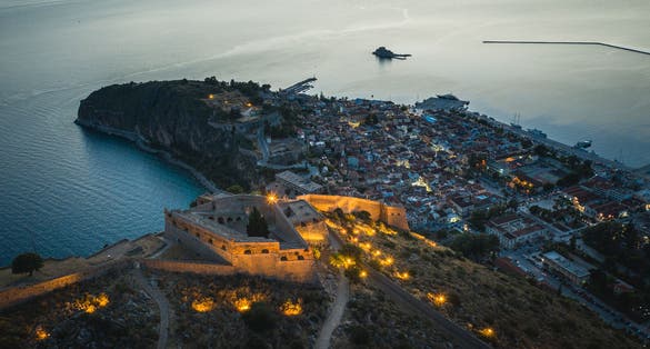 Photo of Nafplio aerial panoramic view of Palamidi fortress at night.