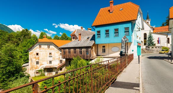 Photo of Amazing view of the medieval city on Capuchin Bridge in Slovenia.
