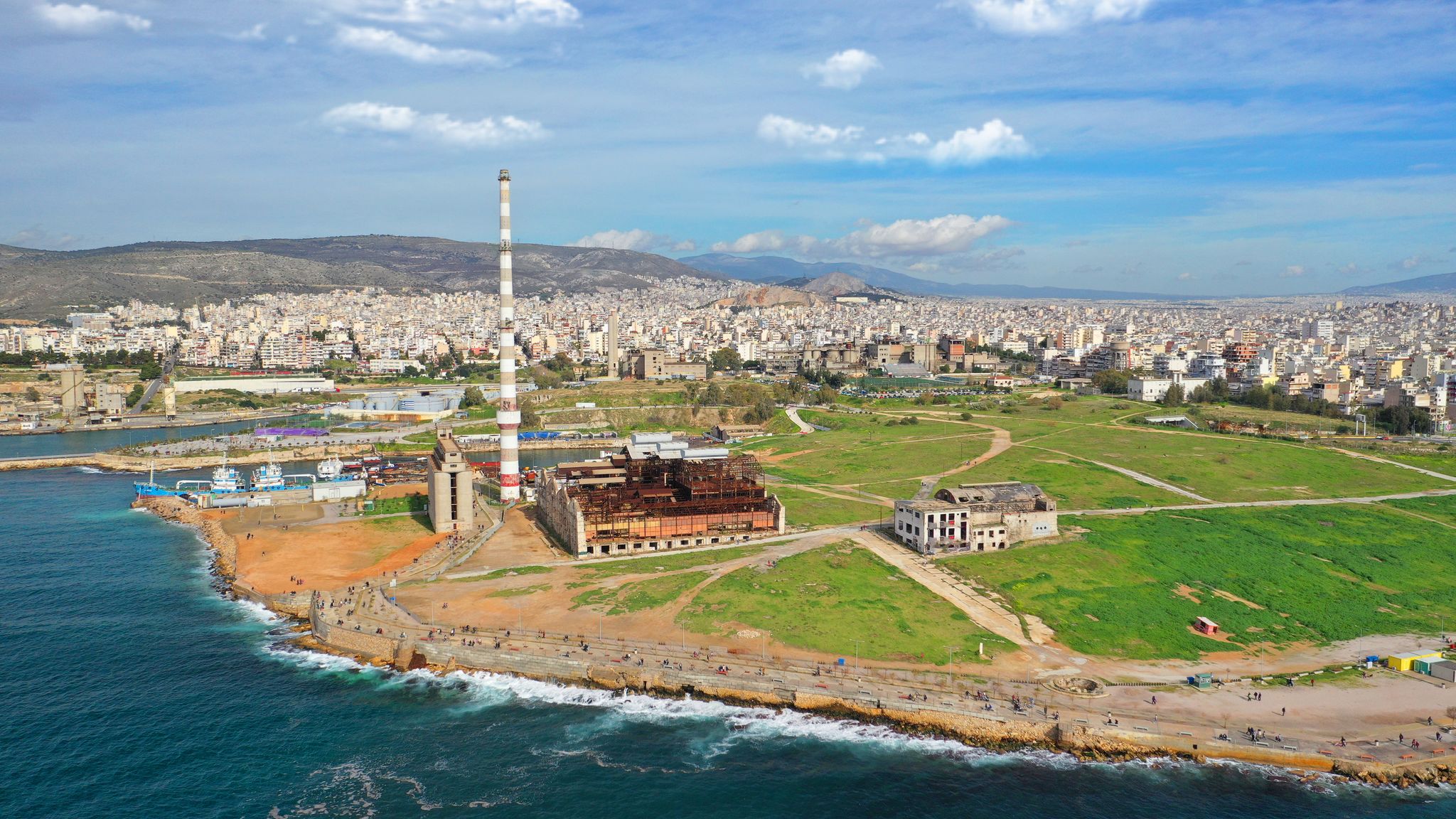 Photo of Aerial drone view from abandoned public fertiliser factory as seen at sunny winter slightly cloudy morning, Piraeus main port, Attica, Greece.
