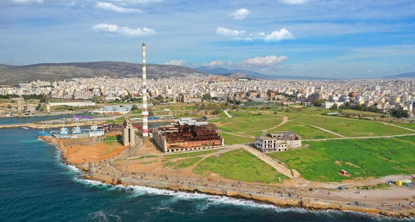 Photo of Aerial drone view from abandoned public fertiliser factory as seen at sunny winter slightly cloudy morning, Piraeus main port, Attica, Greece.