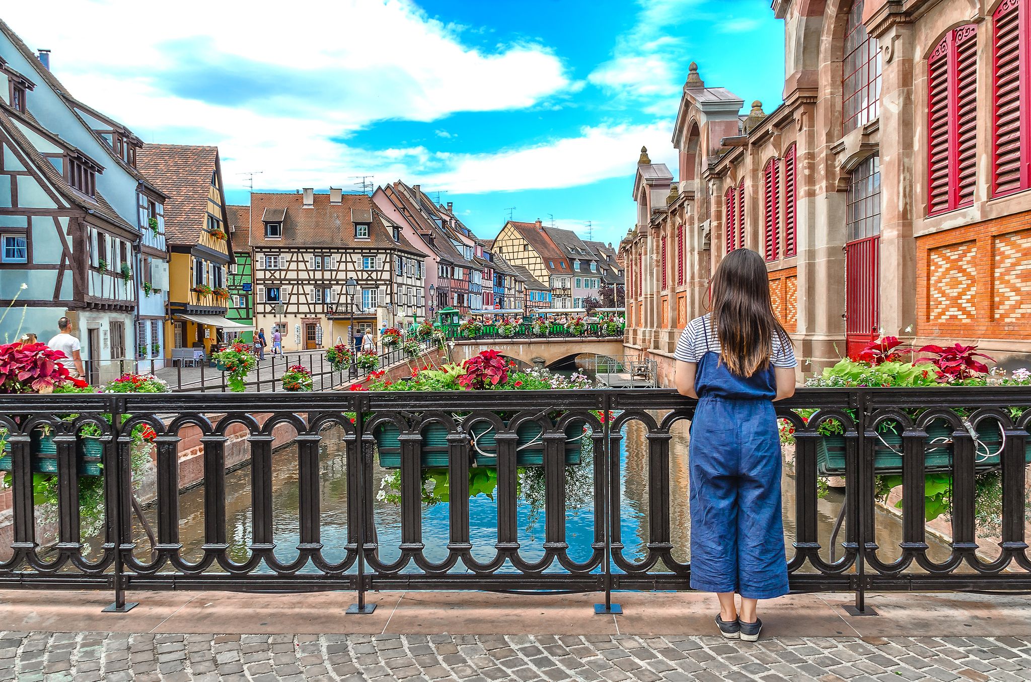 Photo of Asian girl admires the urban landscape of Colmar, France.