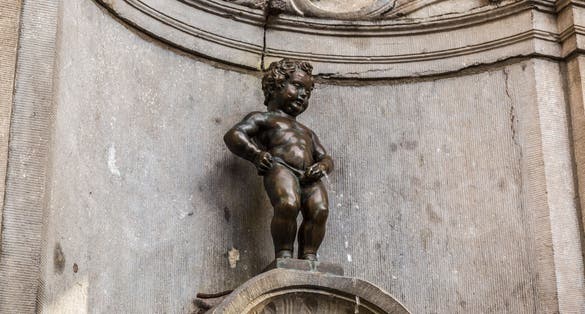 BRUSSELS, BELGIUM - JULY 6: Manneken Pis statue in Brussels. Statue of a pissing boy in a beautiful summer day in Brussels, Belgium on July 6 2014.