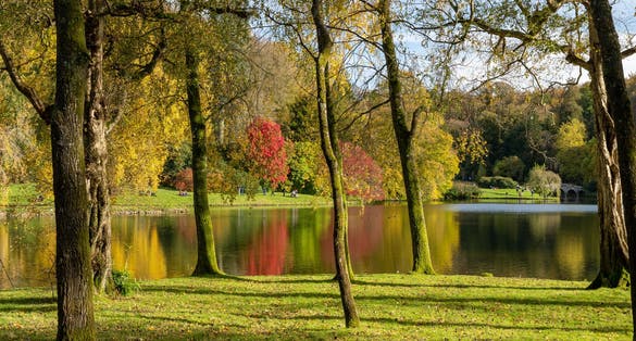 Photo of the autumn colours around the lake at Stourhead gardens, UK.