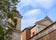 photo of Side View with the Bell Tower of the Basilica of San Clemente in the Center of Rome on a Background of Partly Cloudy Sky,Rome Italy.