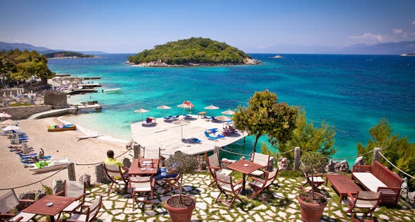 Sunshade umbrellas and deckchairs on the beautiful Ksamil beach, Albania.