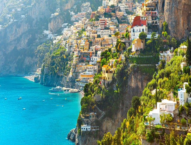 Colorful cliffside buildings overlooking turquoise waters in Positano on the Amalfi Coast in June..jpg
