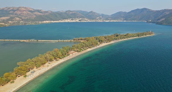 photo of Igoumenitsa Beach Drepanos sand and sea waves under the blue sky tourist place and attraction beautiful in Igoumenitsa city Greece Thesprotia close to Parga Preveza and Sivota Epirus Europe seascape.