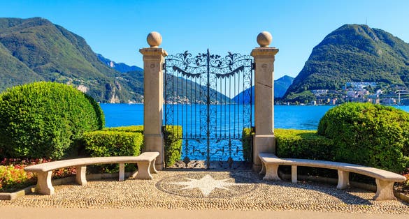 Photo of old wrought iron gate overlooking Lake Lugano in Ciani Park, Lugano, Switzerland.