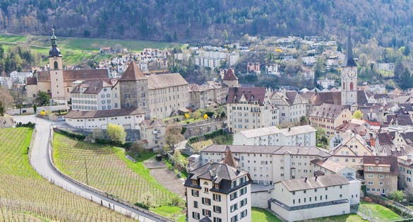 historic city center with church, castle and old houses surrounded by vinyards and mountains in Chur, Switzerland