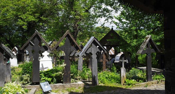 Photo of Ieud Hill wooden monastery and its graveyard, the oldest wood church in Maramures, Romania, Europe - UNESCO Heritage.