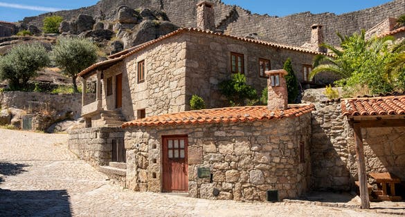 Gothic houses made of stone on deserted alley in Sortelha Castel. Covilha, Castelo Branco, Portugal.