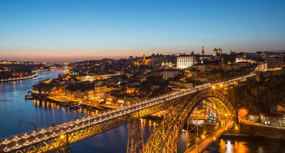 View of Douro River in dusk. Dom Luis Bridge at the night. Porto, Portugal.