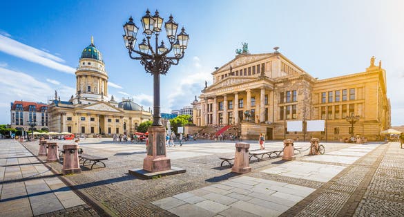Photo of panoramic view of famous Gendarmenmarkt square with Berlin Concert Hall and German Cathedral.
