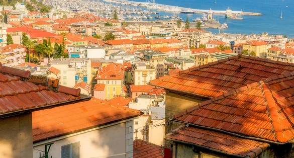 View of Sanremo City, Liguria, Italy showing old town La Pigna and new port. Picture taken from el Santuario Madonna Della Costa on a hill above the city.