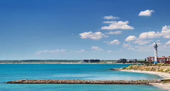 Black Sea coast of Bulgaria with sand beach, lighthouse and blue sky