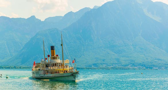 Photo of passenger ferry arriving to the pier at port at Vevey, Switzerland.