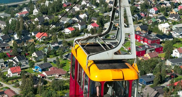 Photo of cable car above Tromso city with the bridge and Arctic Cathedral on background, Norway