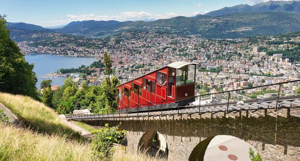 photo of Lugano, canton of Ticino, Switzerland. Monte Brè funicular. Public transport cable car with scenic view over the city.