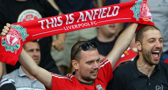  Liverpool supporter with This Is Anfield scarf shows his support.