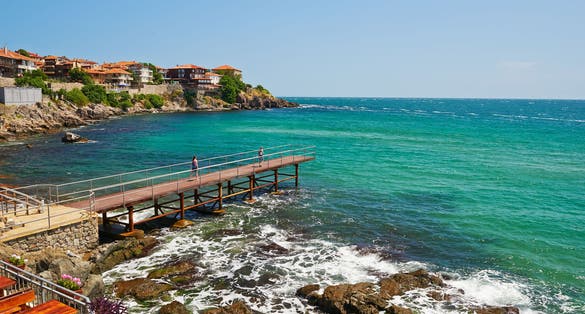 Photo of tourists on the pier looking at the beach of Sozopol in Bulgaria.