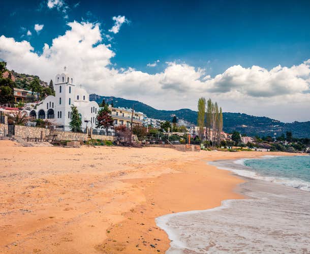 Photo of bright spring view of Orthodox church in Paleo Tsifliki village. Colorful morning scene of Aegean Sea, Greece.