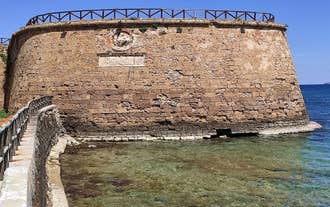 Photo of aerial view of Chania with the amazing lighthouse, mosque, venetian shipyards, Crete, Greece.