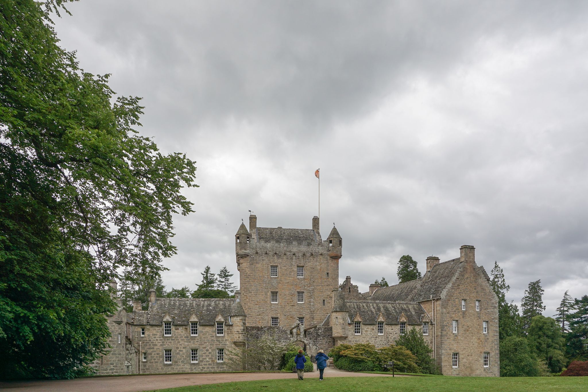 Photo of Cawdor Castle is set amid gardens in the parish of Cawdor in the Highlands of Scotland. The castle is built around a 15th-century tower house.