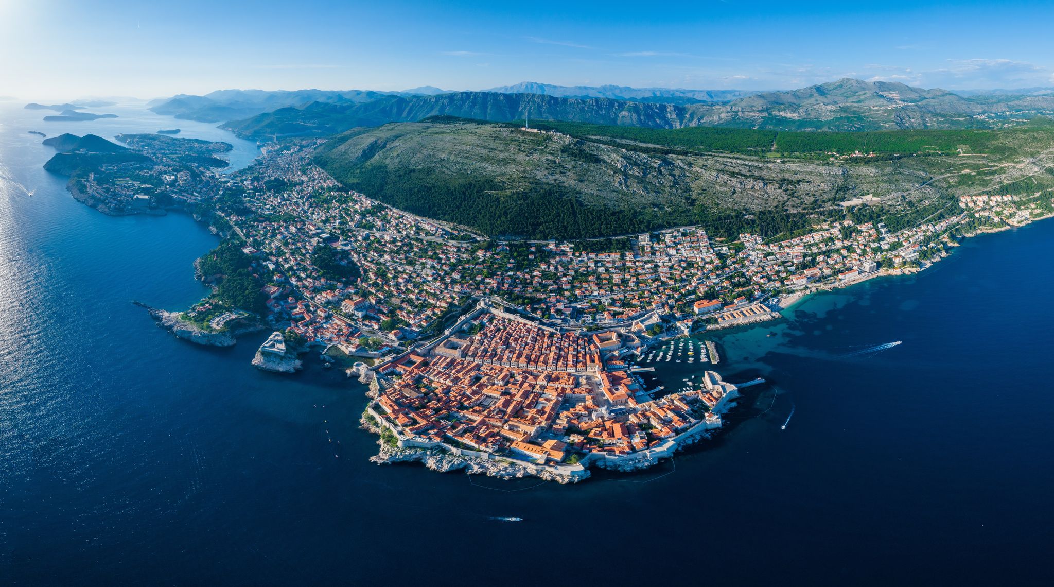 Photo of aerial panoramic view of Dubrovnik and Srd Mountain along the Adriatic coastline, Croatia.