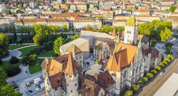 Photo of panoramic cityscape of the Old Town of Zurich and Swiss National Museum, top view.